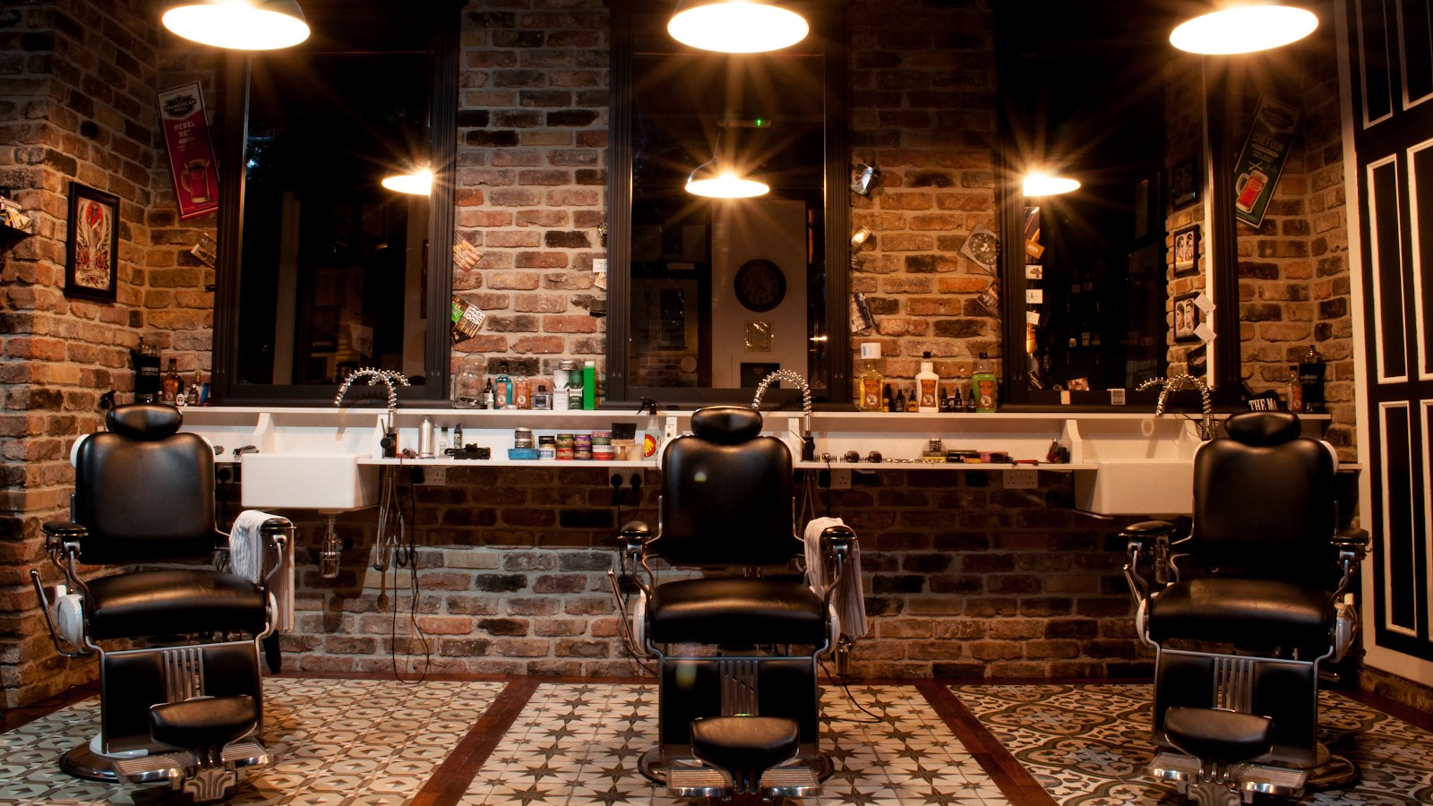 Barber chairs and brick-wall stations inside Tom Winters Barbers, Cork